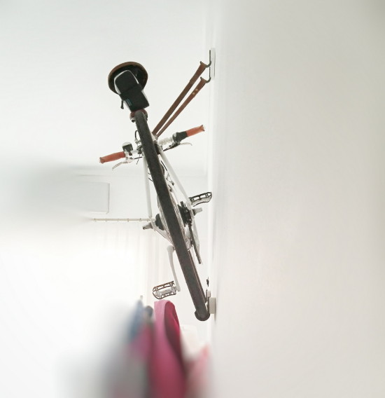 Put the bike pedal that is against the wall at its upmost position.