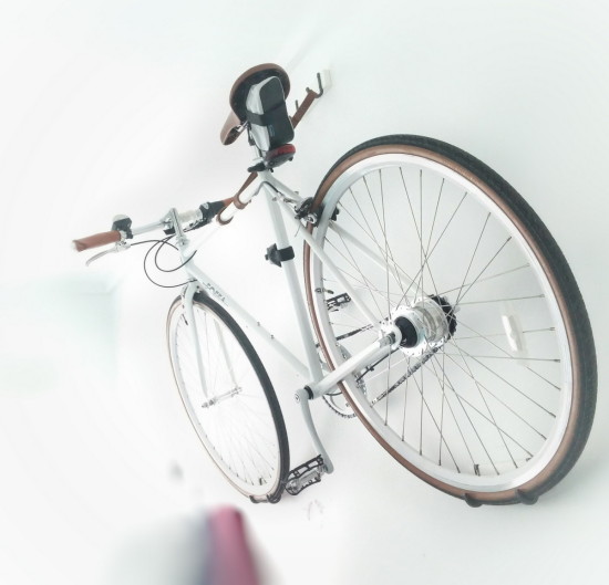 A wall mount bike hanger made from 3 IKEA HJALMAREN towel hangers and a leather strip